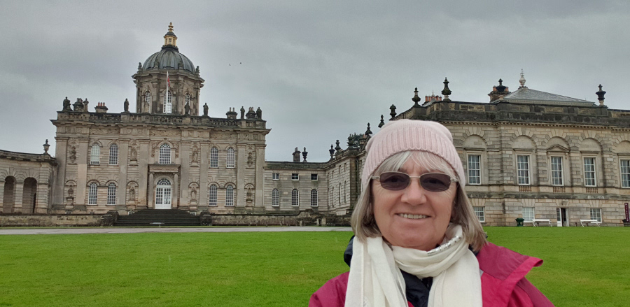 woman smiling into camera in front of English castle