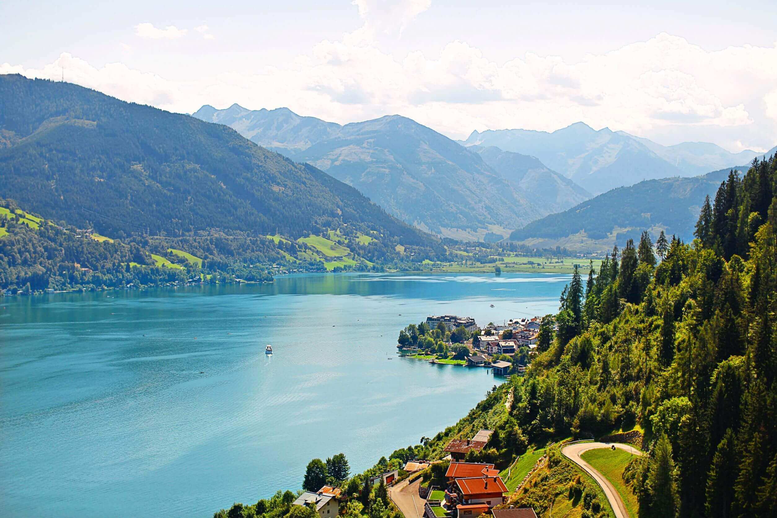 beautiful landscape shot of a blue lake surrounded by green mountains