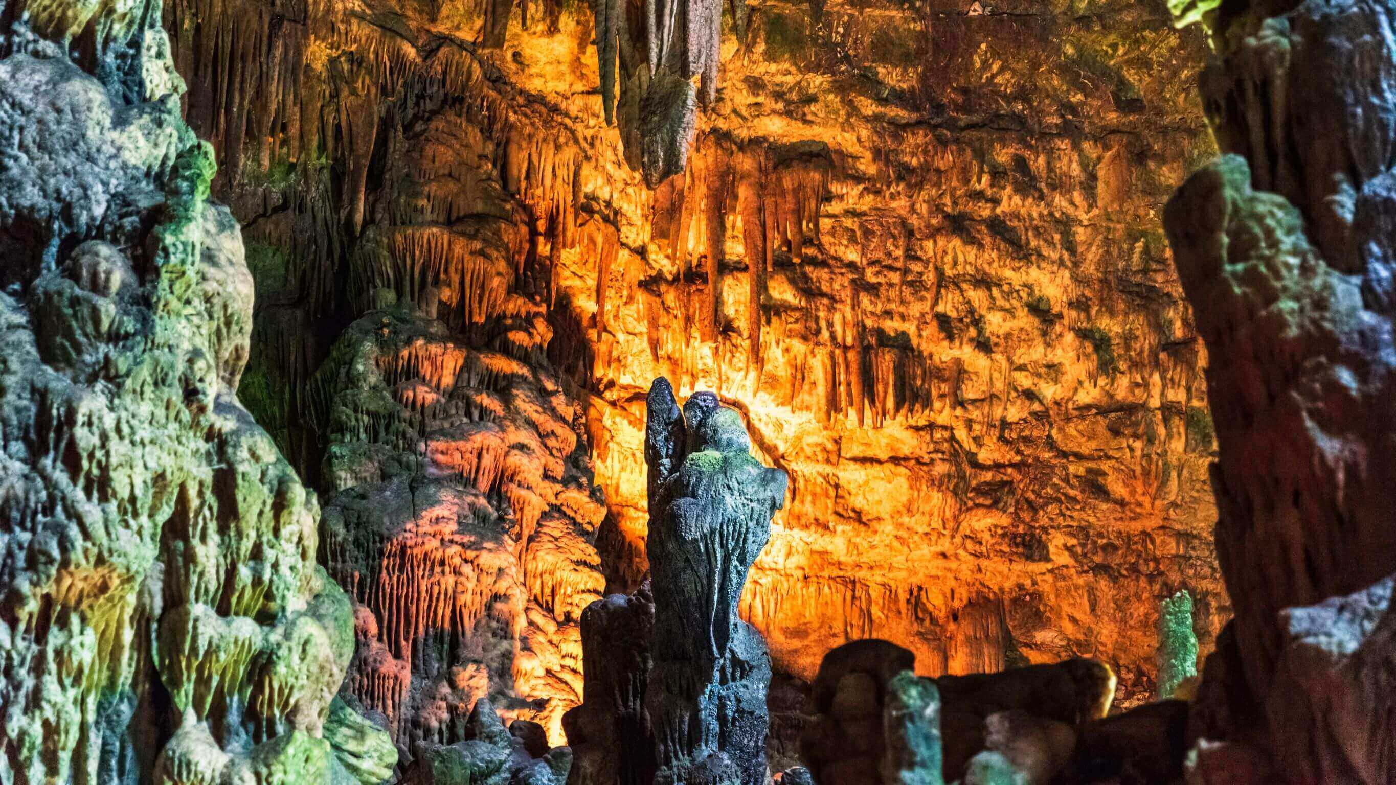 underground Castellana Caves with 2-million-year-old stalactites and an angel in rock formation in the centre 