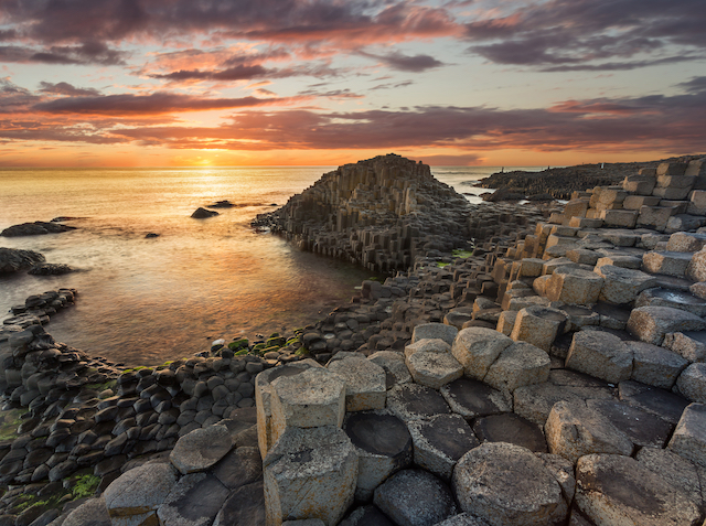 sun setting over the Giant's Causeway in Northern Ireland 