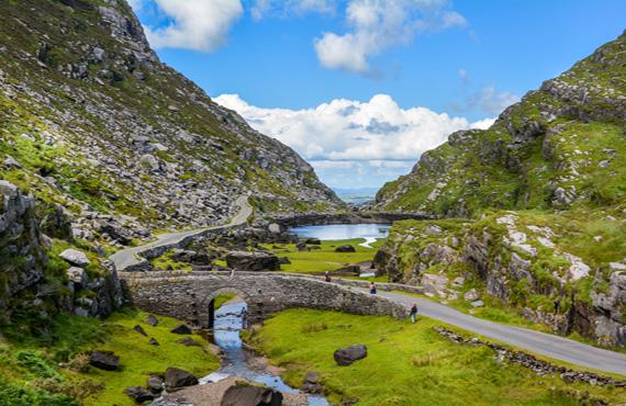 A view of a valley in the Irish county of Kerry, with a river coursing through the bottom.