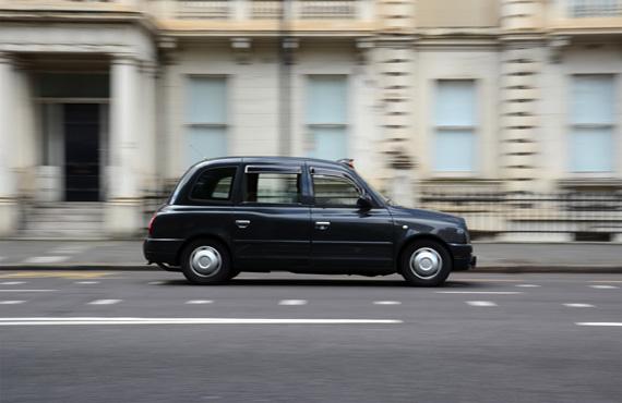 A black cab conducting a tour through the streets of Belfast.