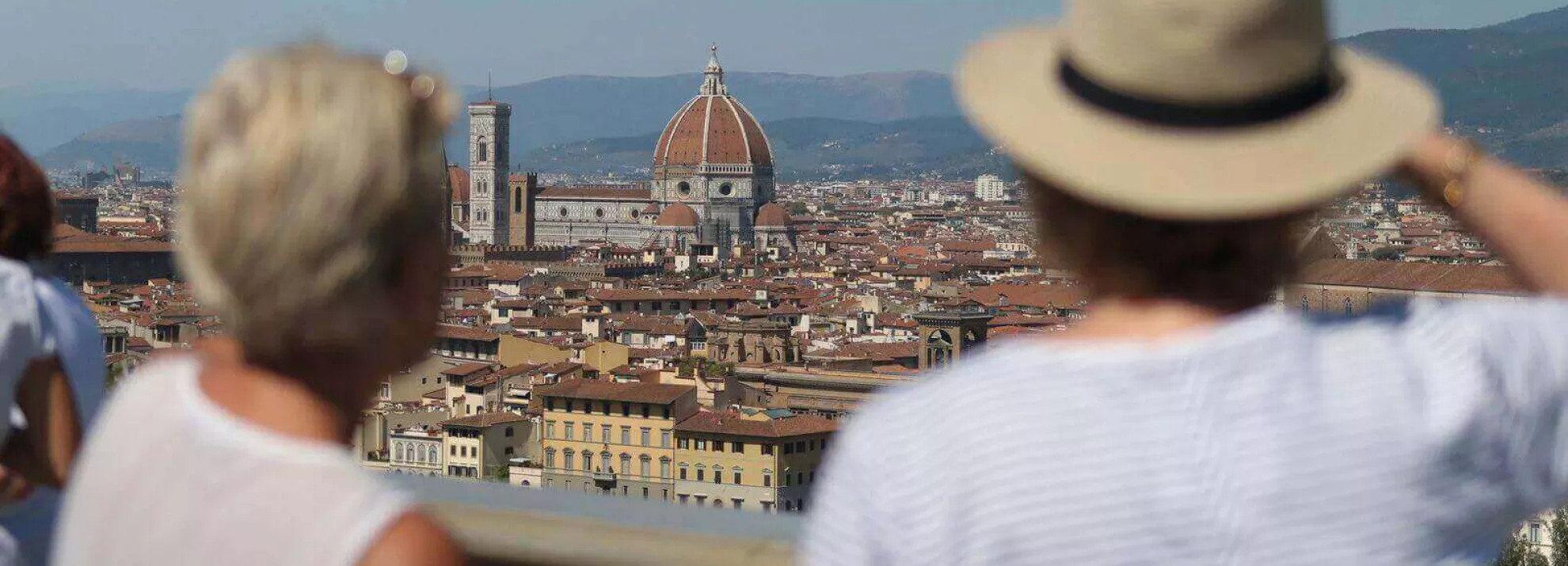 Man and woman overlooking the city of Florence with Florence Duomo in centre