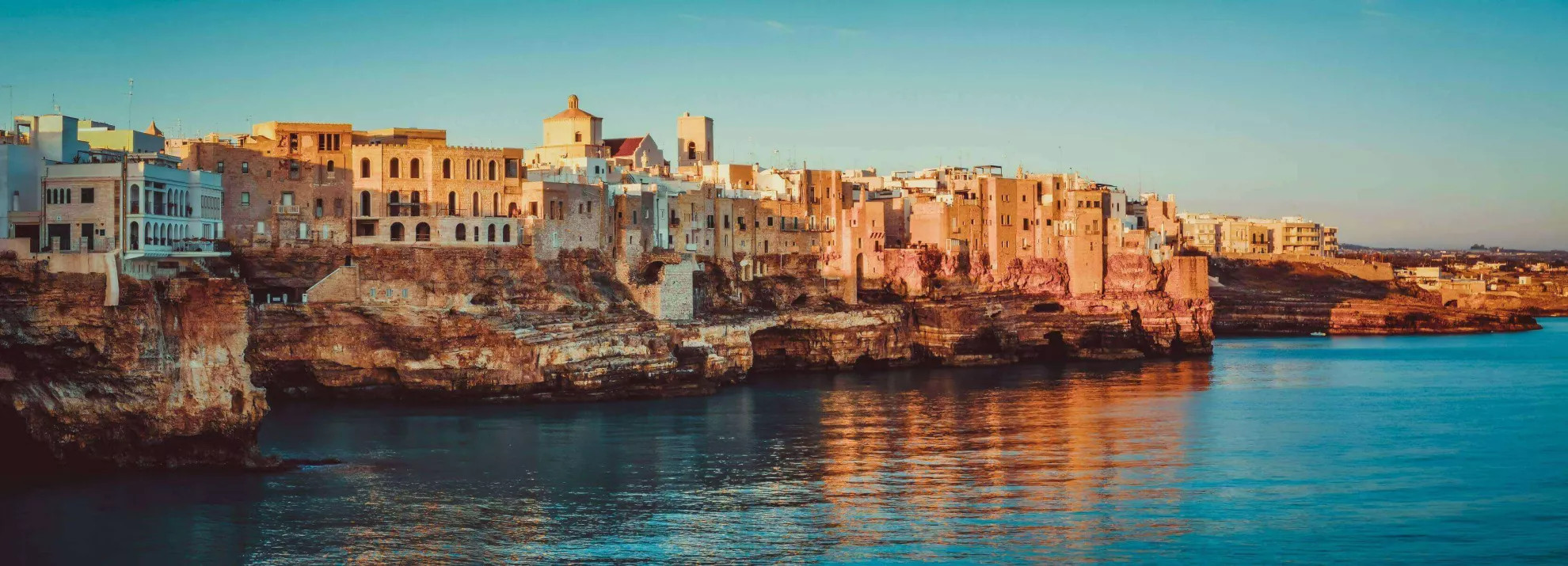 panoramic view of poliagno mare at sunrise (puglia, italy)