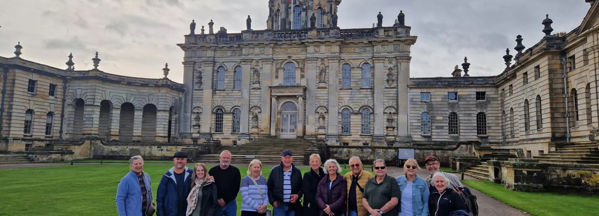 Group standing in front of grand house