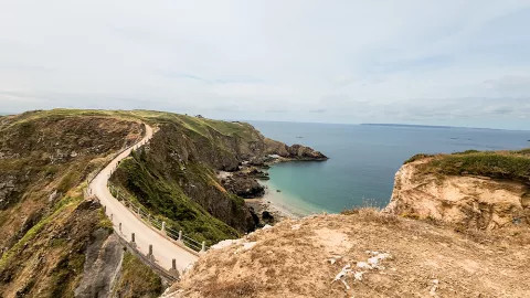 A view of a suspension bridge spanning the coastline of Sark.