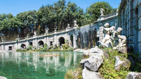 Immaculate stone statues line the the grand fountain at the Royal Palace of Caserta, known as the Fontana di Eilo.