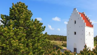 A landscape view of the architectural wonder of Hopperstad Church.