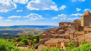 A landscape view of the town of Volterra, with the grand Tuscany countryside in the background.