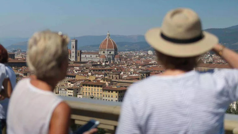 Man and woman overlooking the city of Florence with Florence Duomo in centre