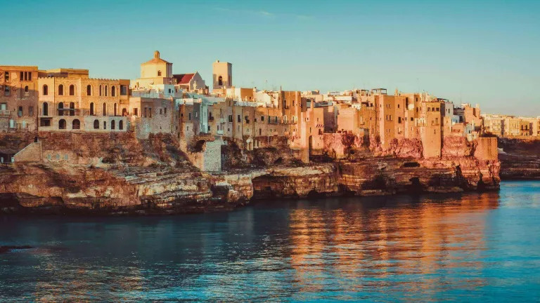 panoramic view of poliagno mare at sunrise (puglia, italy)