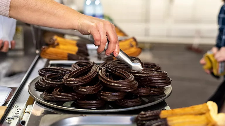 Traditional Spanish breakfast churros bathed in chocolate