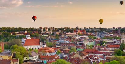 Hot air balloons soar over the Lithuanian capital of Vilnius during the late afternoon.