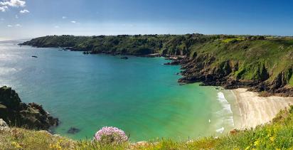 Isolated beach by the coastal cliffs of Guernsey island.