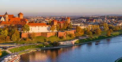 The iconic Wawel Castle overlooking the city of Krakow as the sun sets.