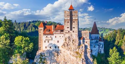 A Landscape view of Romania’s iconic Bran Castle in Transylvania, known for spawning the legend of Dracula.