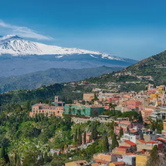 A view of Taormina, Sicily, with Mount Etna in the background.