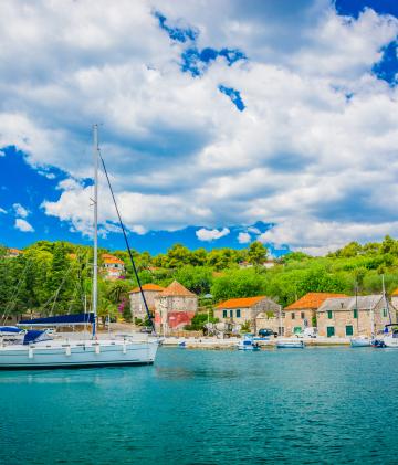 A sailing boat anchored at port.