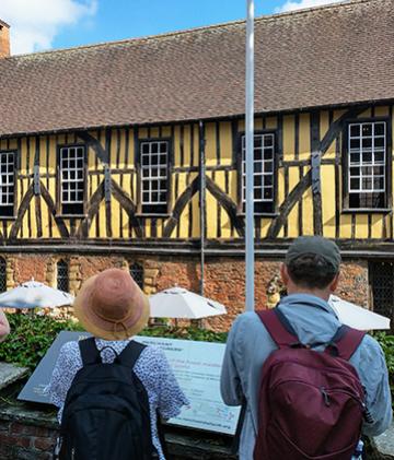 Travelers in front of the Merchant Adventurers' Hall in York.